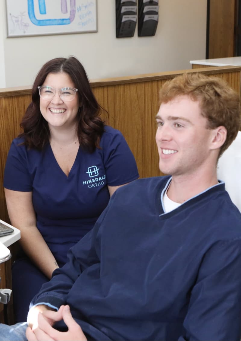 team member and teen talking